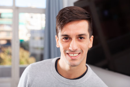 Portrait of stylish young man in living room