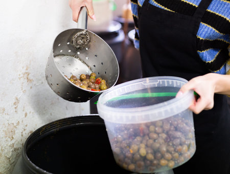 Packing olives in plastic containers