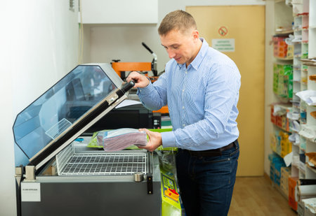 Worker packs notebooks in a vacuum packing