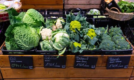 View of showcase with fresh white headed cabbage, cauliflower, broccoli and broccoflower in greengroceryの写真素材