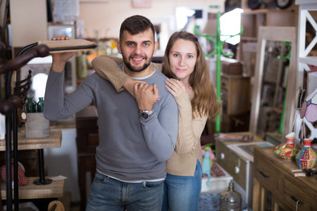 Portrait of man and his girlfriend in antique furnishings storeの写真素材