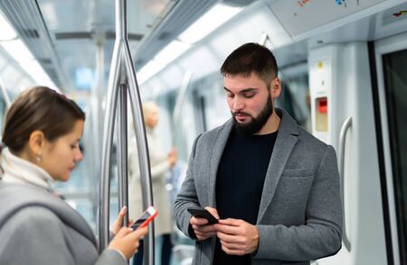 People browsing in smartphone in subwayの写真素材