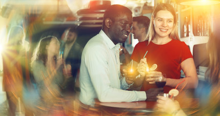 Young african american man flirting with girl on  party at nightclub