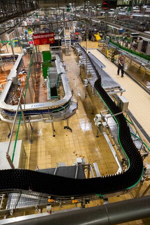 PILSEN, CZECH REPUBLIC - OCTOBER 10, 2019: Inside view of bottling department of Pilsner Urquell brewery with beer bottles on conveyor beltのeditorial素材