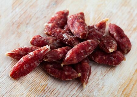 Popular spanish small snack sausages secallones on wooden surfaceの写真素材