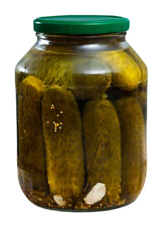 Pickled cucumbers with spices in glass jar. Isolated over white background
の写真素材