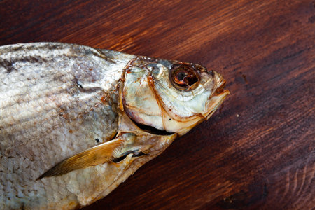 Closeup of air-dried salted freshwater bream on wooden background
