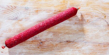 Fuet nobleza, traditional spanish dry cured sausage on wooden tableの写真素材