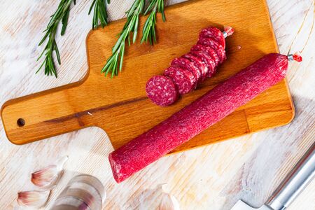 Dried sausage on cutting board. Traditional spanish meat productの写真素材