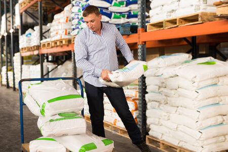 Middle-aged man buying materials for home renovation in paint storeの写真素材