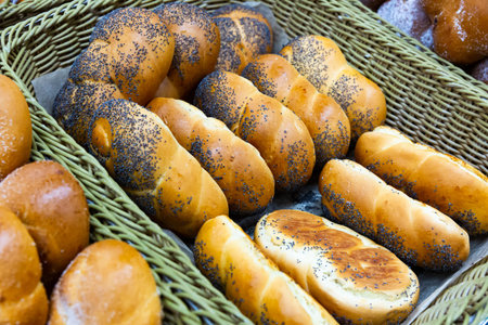 Variety of freshly baked sweet buns on counter of bakery shop