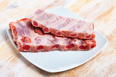 Raw fesh spare ribs on a wooden surface