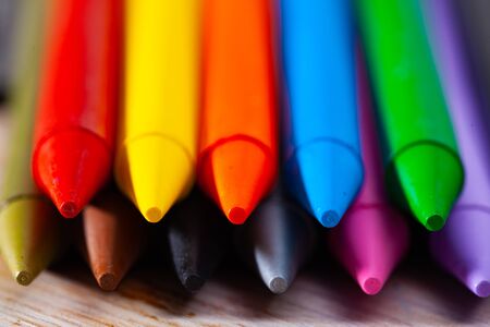 Multicolored wax chalks on wooden background. Concept of artistic education の写真素材