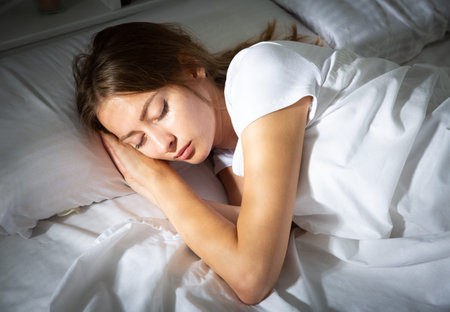 Attractive girl in underwear sleeping in her bed