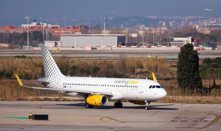 BARCELONA, EL PRAT,  SPAIN - JANUARY 26, 2020: Image of Passenger Airplane of Vueling airlines is preparing for take off  from airportのeditorial素材