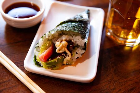 Temaki with tuna and avocado traditionally served with soy sauce and beer. Japanese cuisineの写真素材