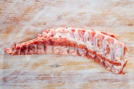 Uncooked pork ribs rack on wooden tableの写真素材