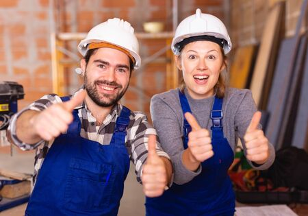 Two professional builders with thumbs upの写真素材