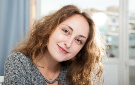 Portrait of attractive Caucasian woman at home in good moodの写真素材