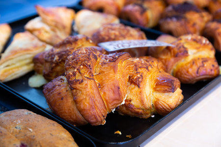 Image of fresh chocolate croissants, spanish dessert on counter in supermarket
