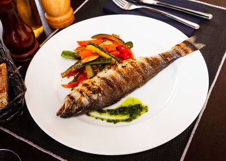 Tasty grilled sea bass with grilled zucchini, pepper and mushroomsの写真素材
