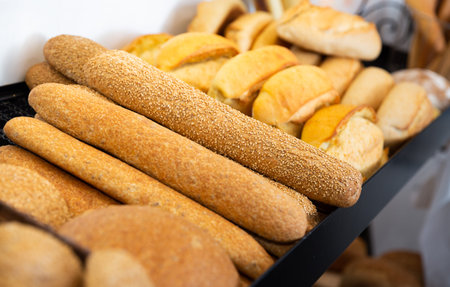 Interior of traditional Spanish bakery shop with showcase full of fresh baked goods