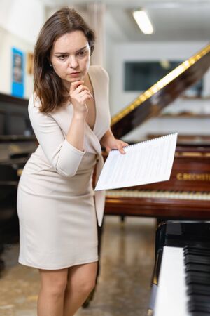 Saleswoman assistant in piano music storeの写真素材