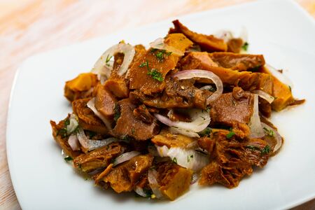 Plate of pickled red pine mushrooms (lactarius deliciosus) with onion and dillの写真素材
