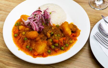 Appetizing spicy veal with potatoes in gravy and rice â Peruvian dishの写真素材