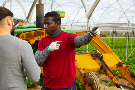 Quarrel of two farmers in greenhouse