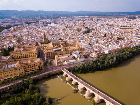 Aerial view of Historic centre of Cordoba with antique Roman Bridge over Guadalquivir river and medieval Mosque-Cathedral, Spainの写真素材
