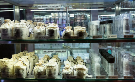 WIELICZKA, POLAND - MARCH 11, 2020: Variety of saltcellars and small bags with rock salt as...