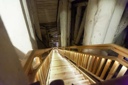 WIELICZKA, POLAND - MARCH 11, 2020: Wooden stairways between levels, corridors and chambers in underground labyrinth of Wieliczka salt mineのeditorial素材
