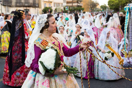 VALENCIA, SPAIN - MARCH 18, 2019: People in Spanish national costumes walking through streets of Valencia during Fallesのeditorial素材