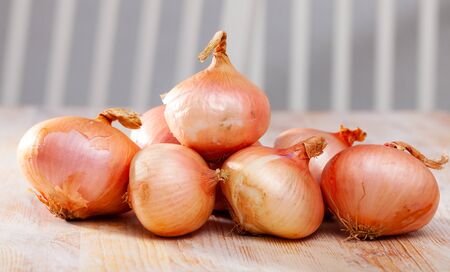 Onion on wooden surface closeupの写真素材