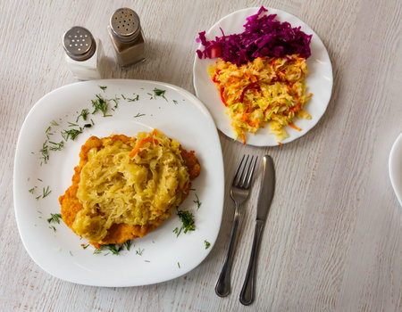 Polish traditional dish - fried pork loin with sauerkraut garnished with dill