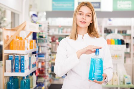 Cheerful female pharmacist demonstrating assortment of pharmacyの写真素材
