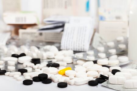 Closeup view of different pills spilled on white backgroundの写真素材