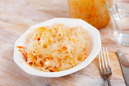 Homemade pickled cabbage on white plate, natural probioticの写真素材