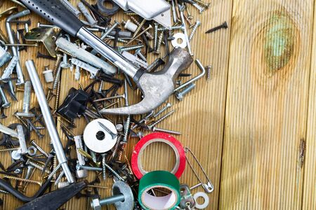 Various fasteners, supplies and hand tools on wooden table with copyspaceの写真素材
