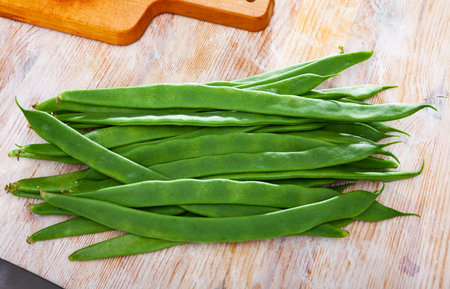 Vegetable ingredients for cooking, organic green peppers on wooden table