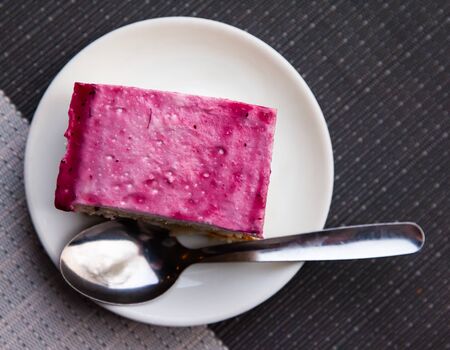 Appetizing cake with raspberry glaze on white plateの写真素材