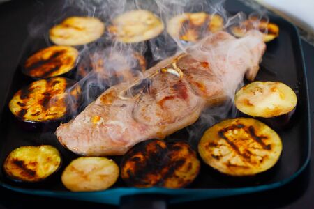 Close-up of delicious pork with eggplant frying on grillの写真素材