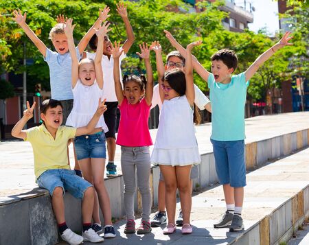 Happy kids playing on summer city streetの写真素材