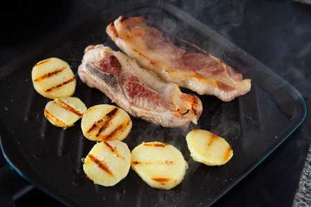 Barbecue grilled pork meat and prepared potatoes