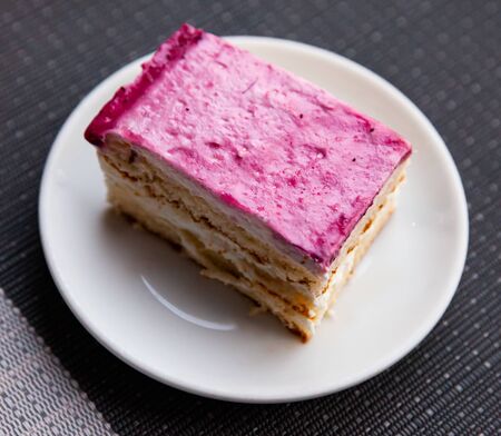 Appetizing cake with raspberry glaze on white plateの写真素材