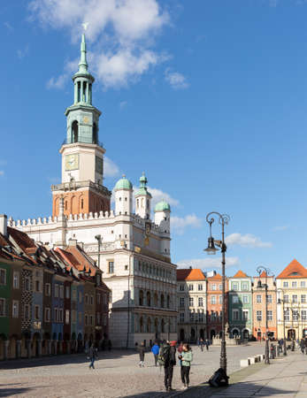 POZNAN, POLAND - MARCH 14, 2020: Renaissance building of historic Poznan Town Hall surrounded by colorful townhouses on Old Market Square  in sunny dayのeditorial素材