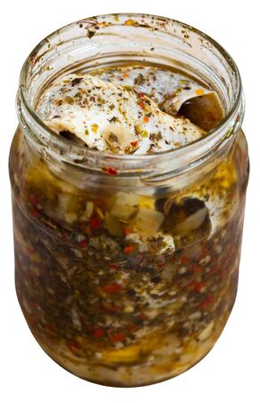 Jar of homemade marinated herring with onion, assorted peppers, vinegar, olive oil, sea salt. Isolated over white backgroundの写真素材