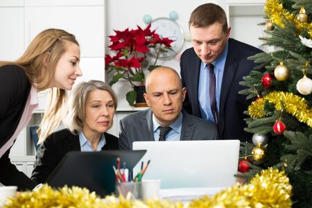 Group of successful managers sums up their work for the year in the officeの写真素材