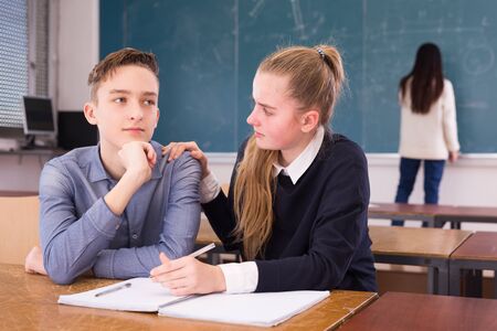 Thoughtful young students during writing notes in classroom,  female student writing on whiteboardの写真素材